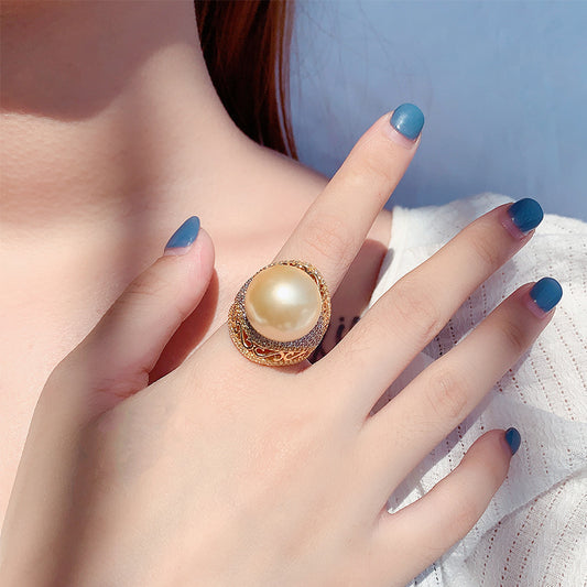 Luxurious Golden Pearl Ring with Shimmering Crystal Accents